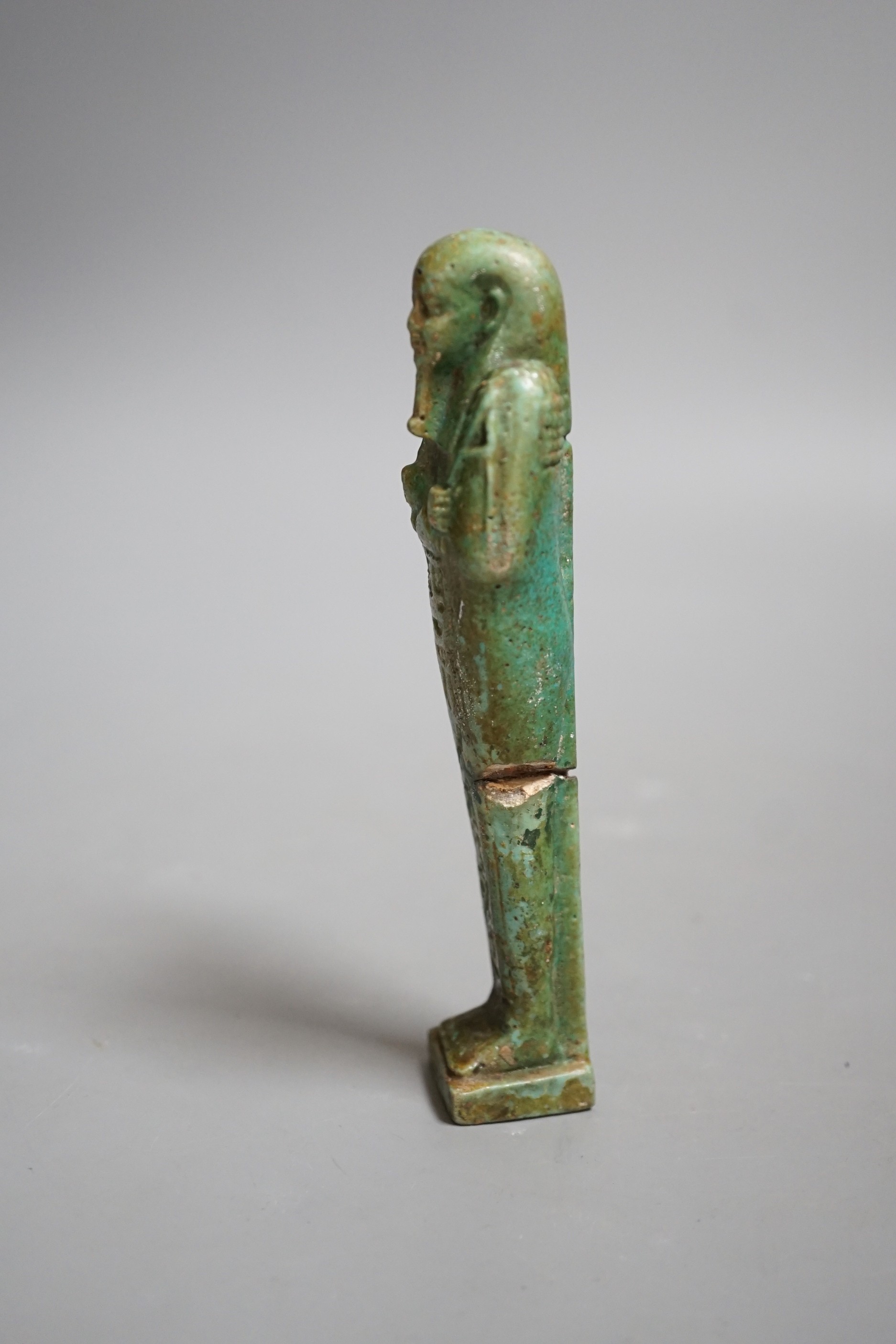 An Egyptian turquoise glazed faience ushabti, possibly Late Kingdom. 14.5cm